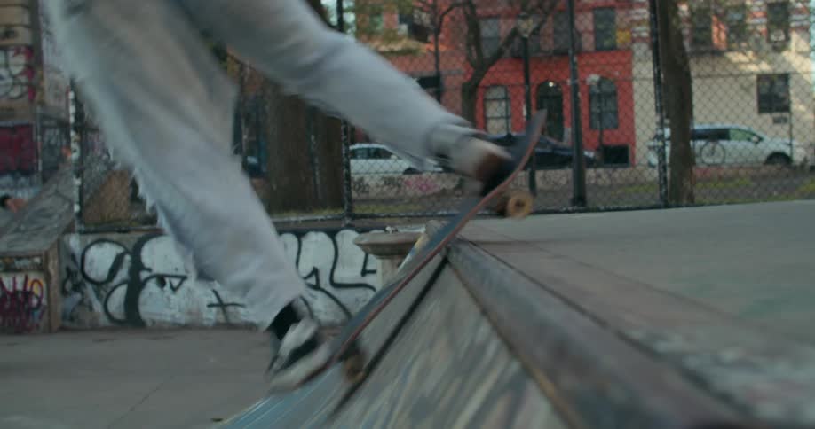 Skateboarder rolls up and down a ramp at a skate park