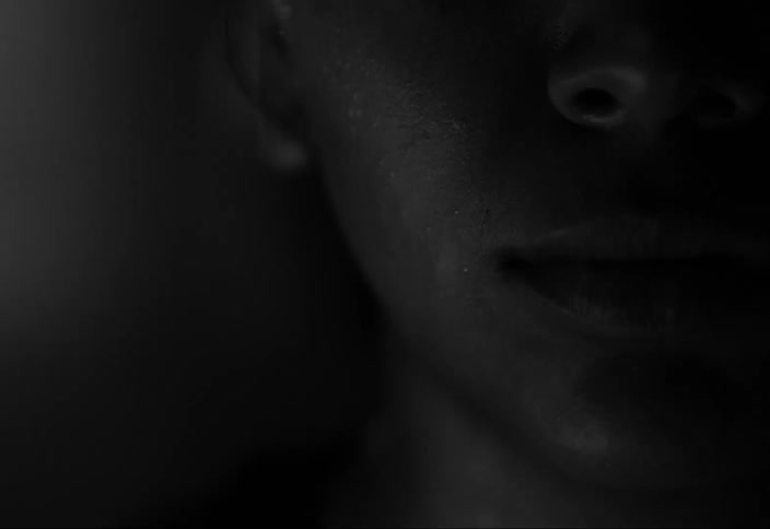 A closeup of a persons lower face and nose under strobing lights