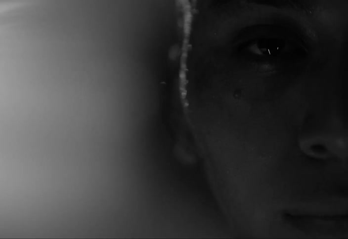 Side face portrait of a woman with sweaty body and flashing lights