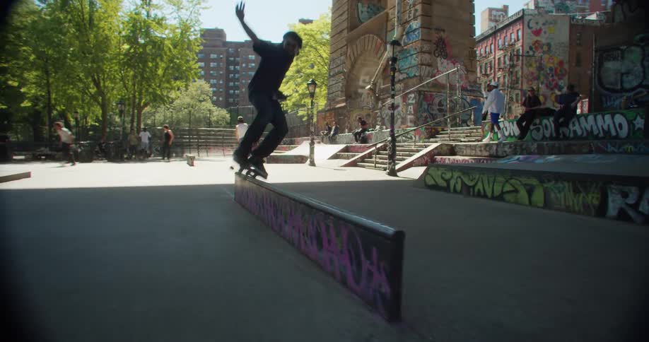 A skater boy performing skateboarding tricks at a skate park in the city
