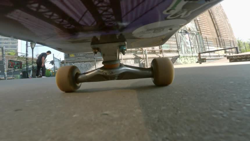 View from below of a skateboard doing tricks at a skate park