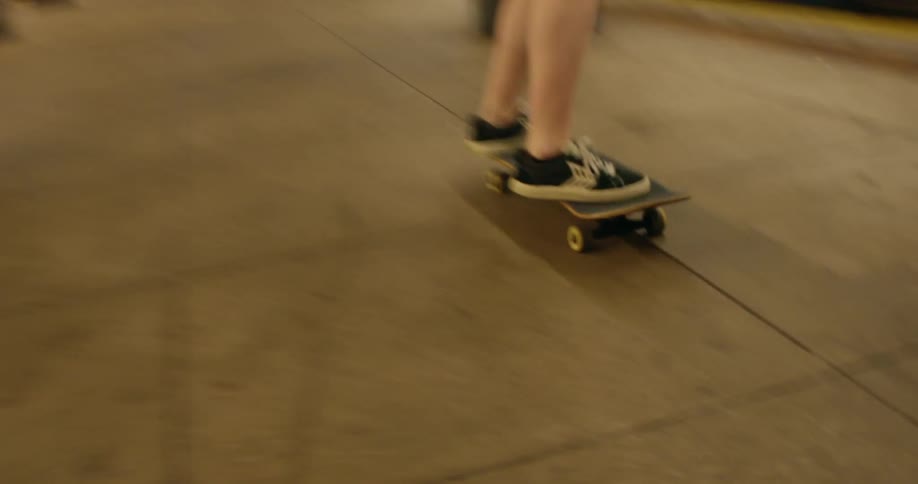 Panorama of two friends skateboarding in a subway station