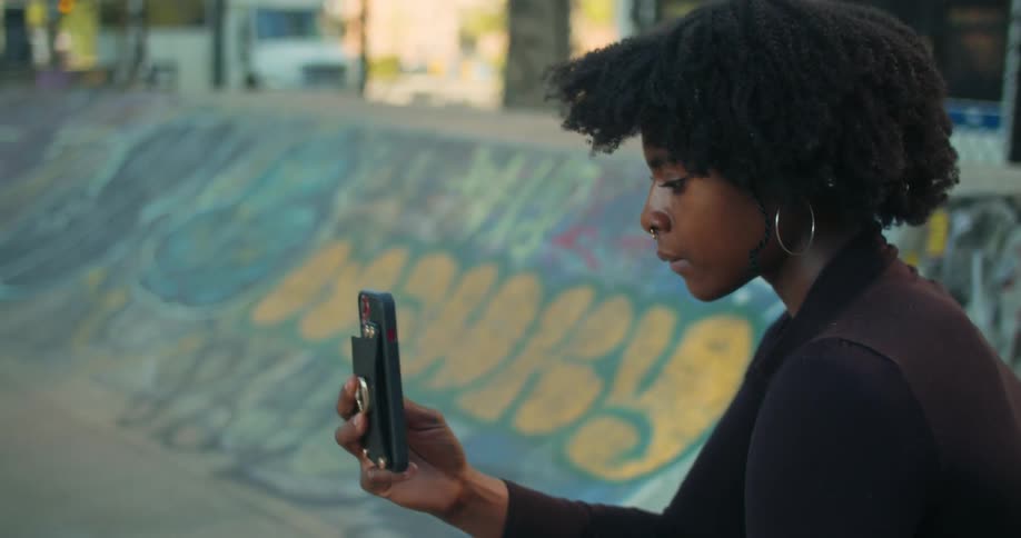 A woman is recording someone skateboarding