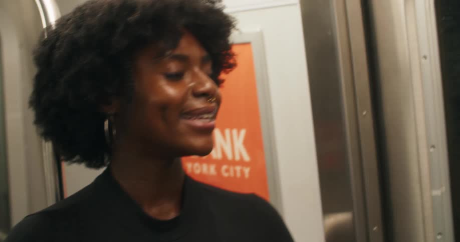 Portrait of a smiling woman talking inside the moving train