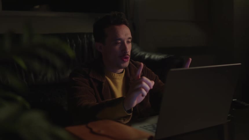 A man is talking to his laptop