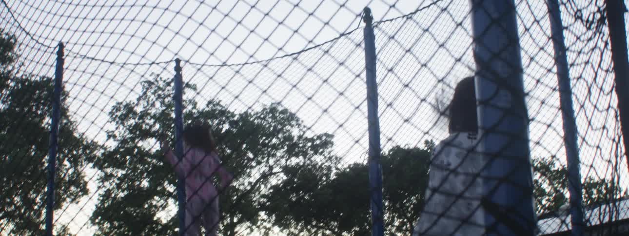 Two children have fun jumping on a trampoline