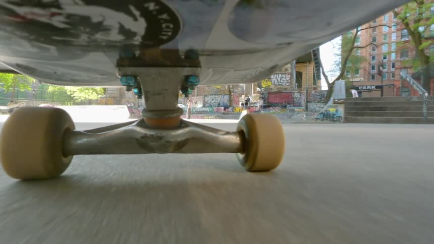 View from below of a skateboard in motion in a square