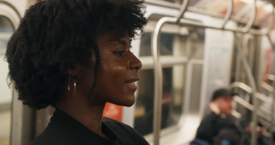 Portrait of a young woman inside a train talking