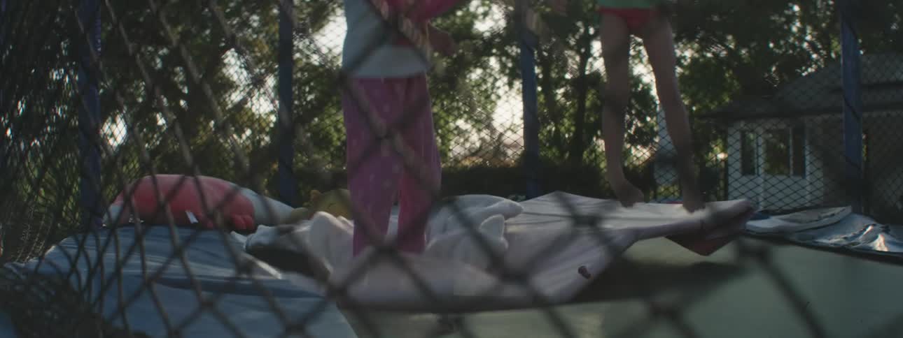 Two girls jumping on a trampoline on a mat