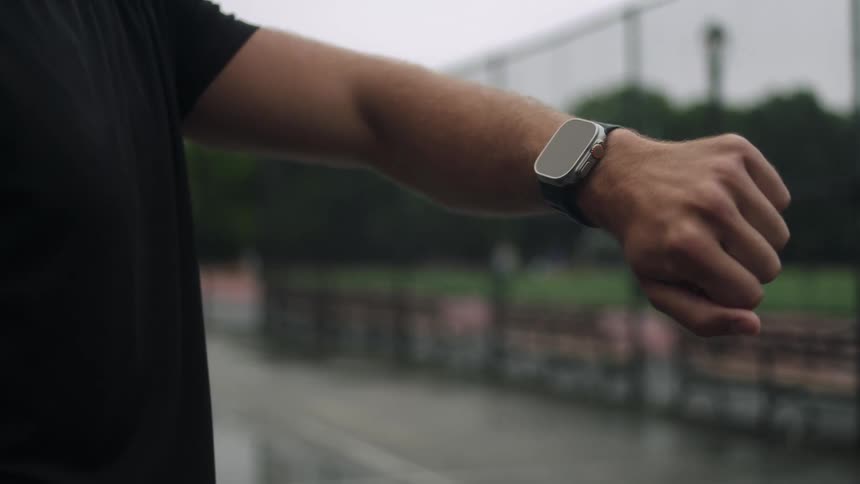 Arm of a man checking his smart watch