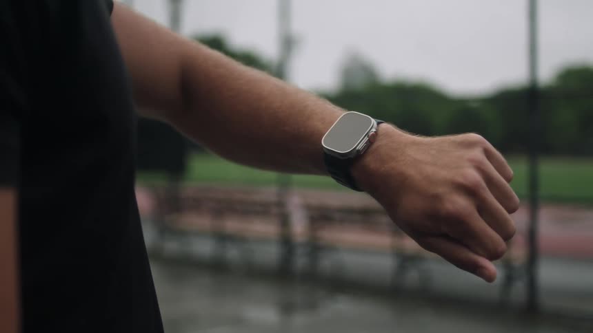 A closeup of a persons arm with a smartwatch on the wrist