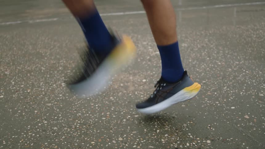A man is jogging in place on a tennis court