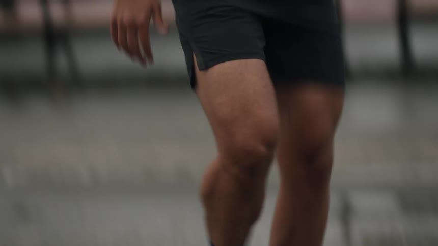 A man jogs on a tennis court