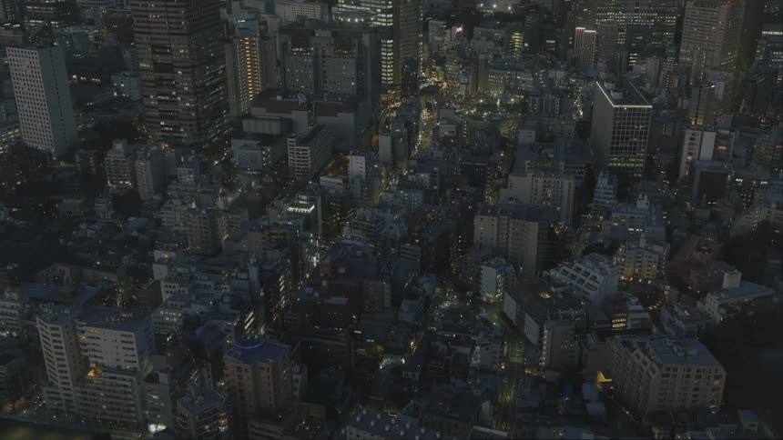 An aerial view of a downtown metropolitan cityscape at night