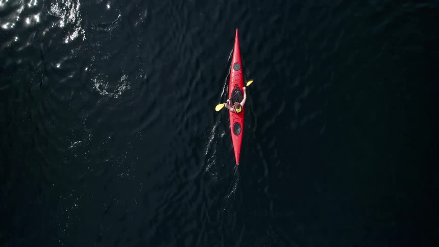 Two people kayaking across a body of water