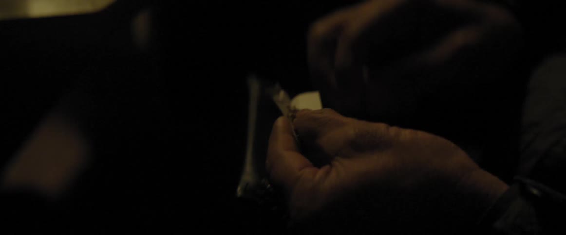 A man rolls his own cigarette