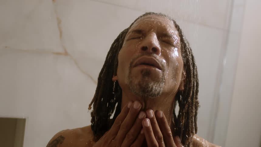 A man is showering in the bathroom