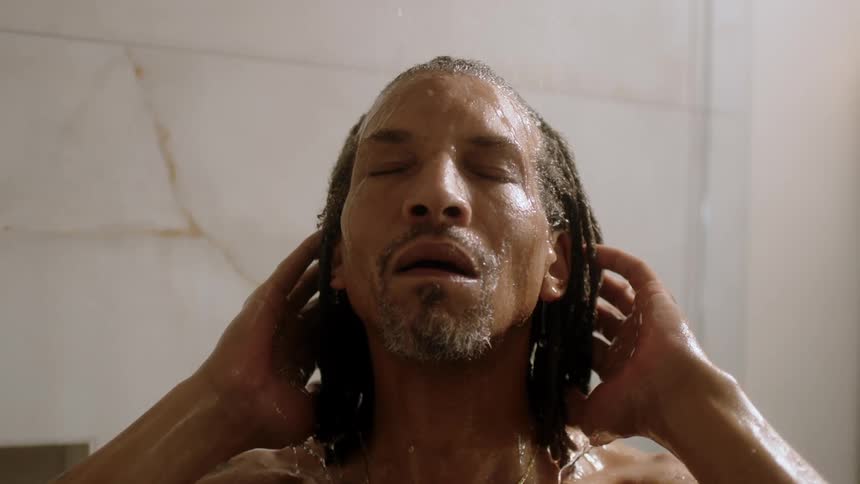 A man takes a shower in slow motion