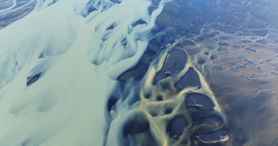 Glacier rivers and a larger body of water frozen solid