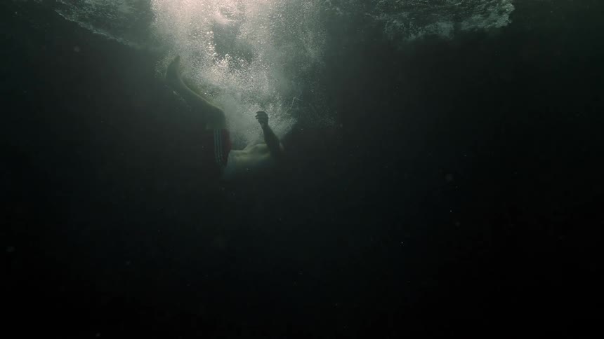 A white male drops into a deep body of water