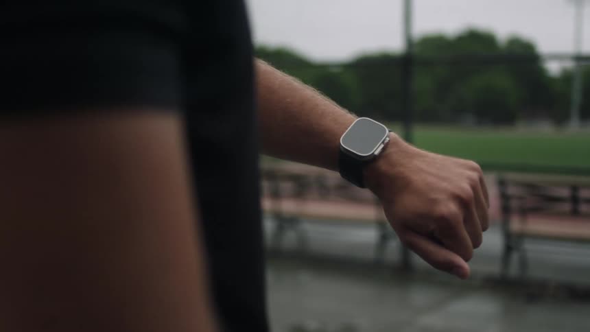 A man is looking at his watch