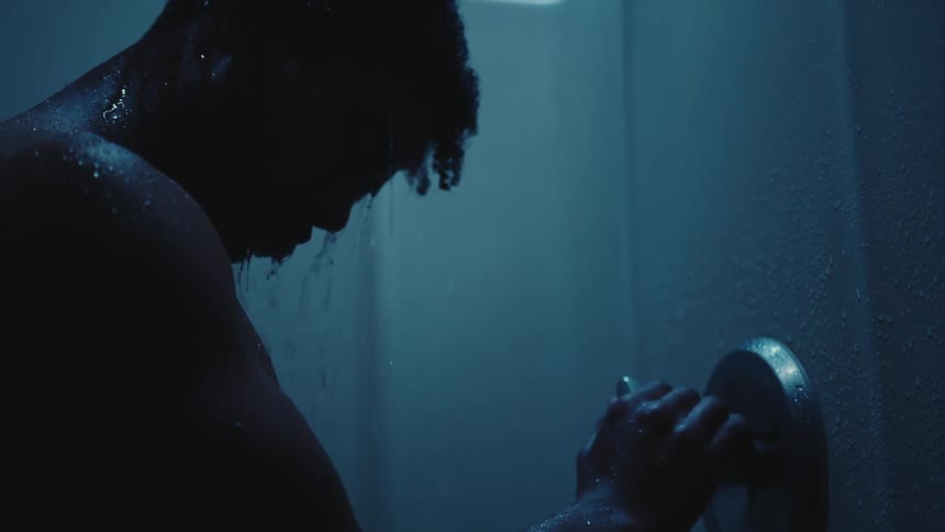 Silhouette of a man taking a shower