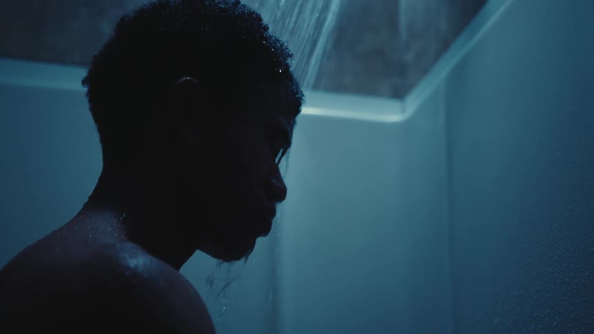 Side silhouette of a sad man in the bath