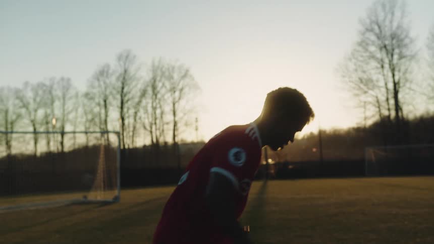 A man is practicing on a soccer field