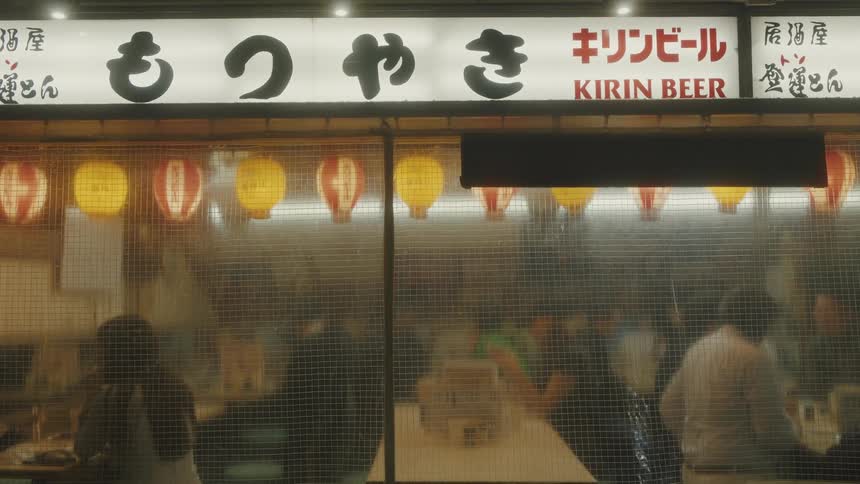 Outside view of people in a japanese restaurant at night