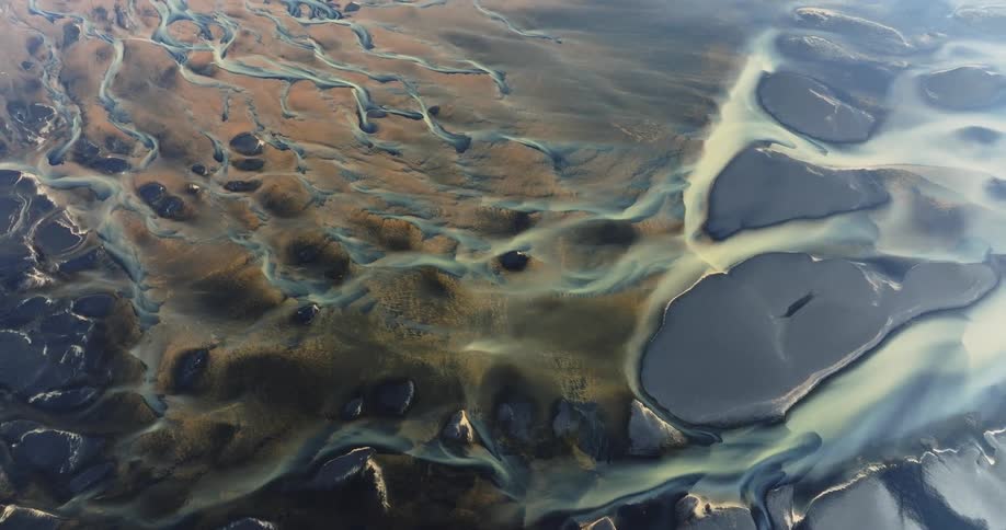 Aerial view of a landscape with various shades of brown and blue