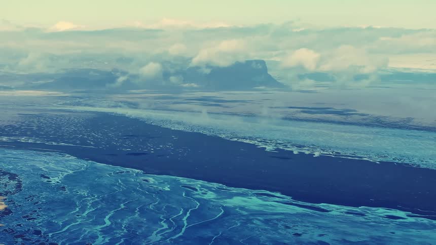 The shore is frozen by the mountains