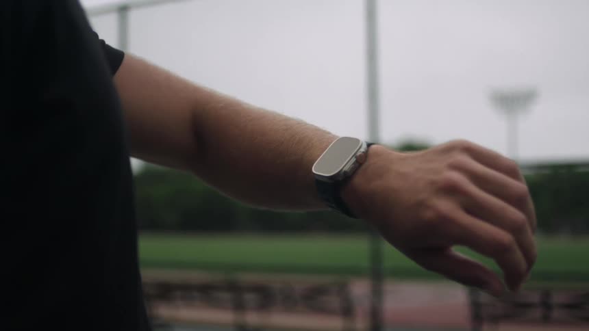 A man checks his watch and walks