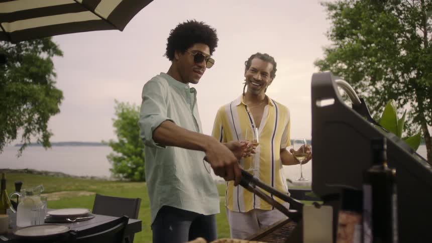 A man is cooking food on the barbecue