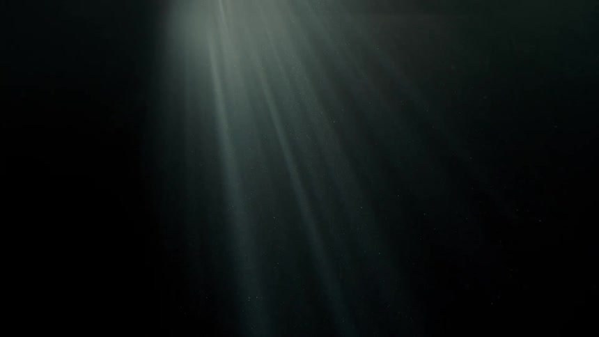 A white light coming from above on a completely dark background