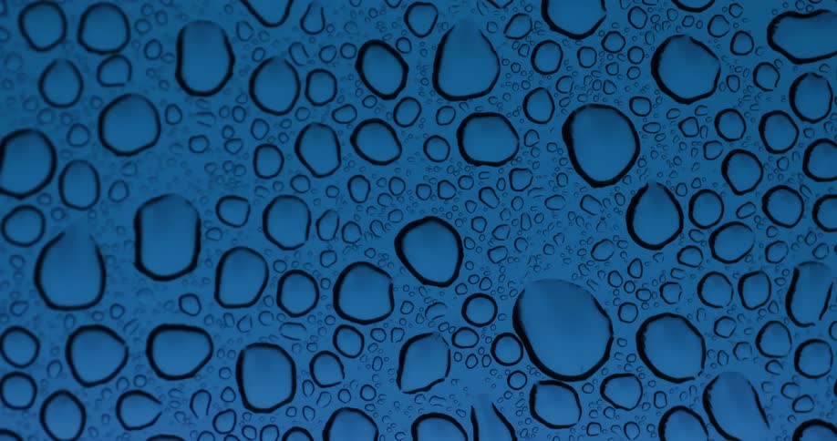 Several drops of water condensed on a glass surface