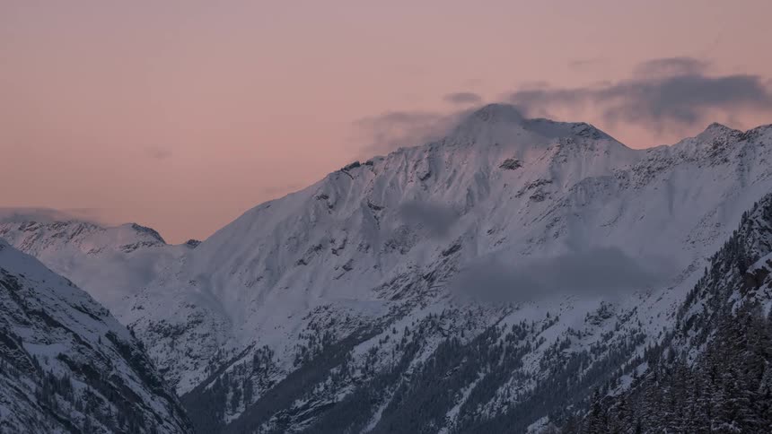 Time lapse footage of a mountain range in the winter