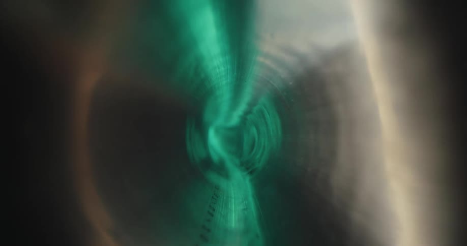 Extreme closeup on a thin tube with neon colors