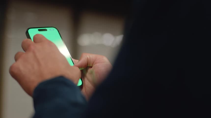 A man scrolling on his smartphone