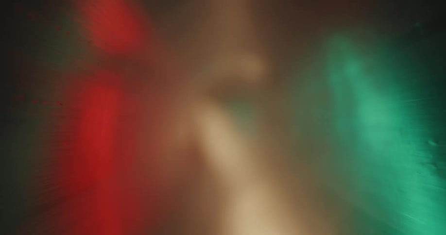 Interior view of a thin plastic tube with the color of neon lights reflecting it