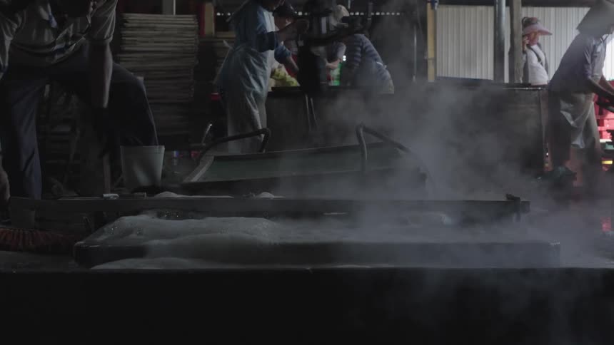 Chinese workers wearing conical hats working at a factory
