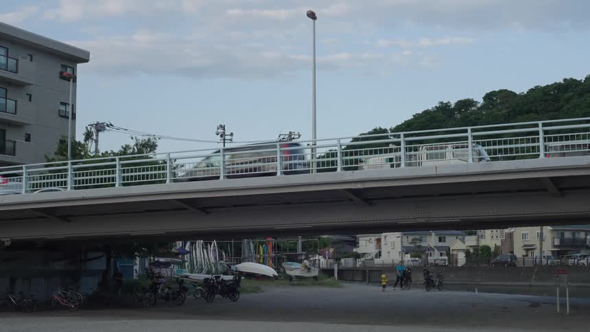 Viaduct with vehicles passing through urban buildings and houses