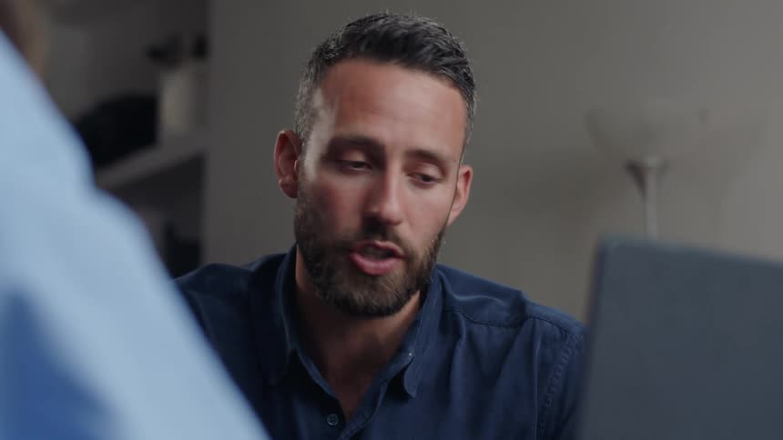 Clip of a man in front of a laptop talking