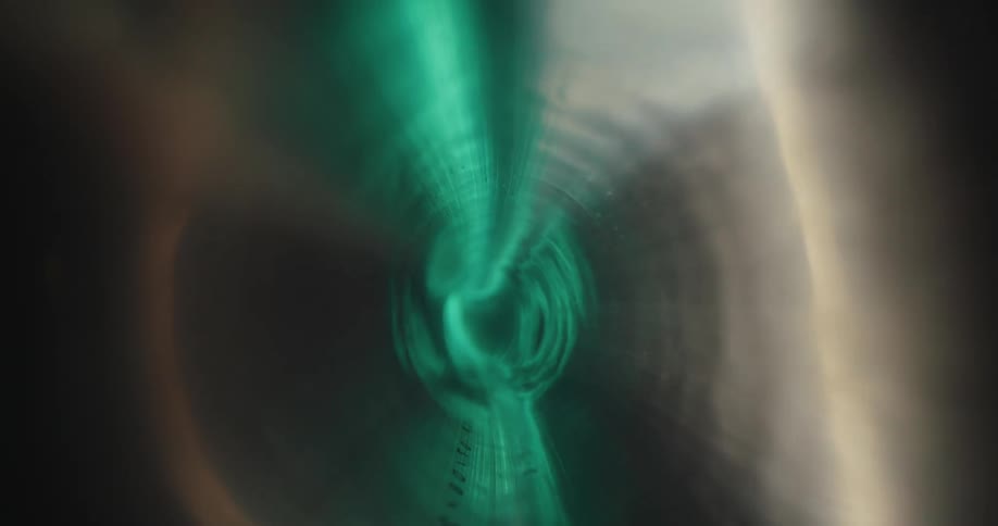 The interior of a semi translucent plastic tube with green lights reflecting outside