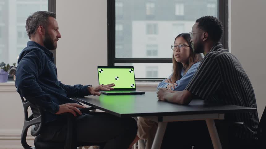 Three people are having a meeting in the office