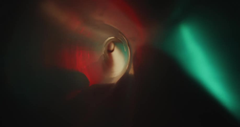 Extreme closeup inside a tube with neon colors on the outside