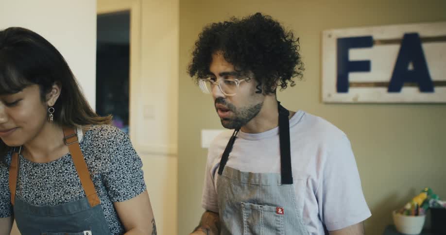 Man and woman cooking in the kitchen side by side