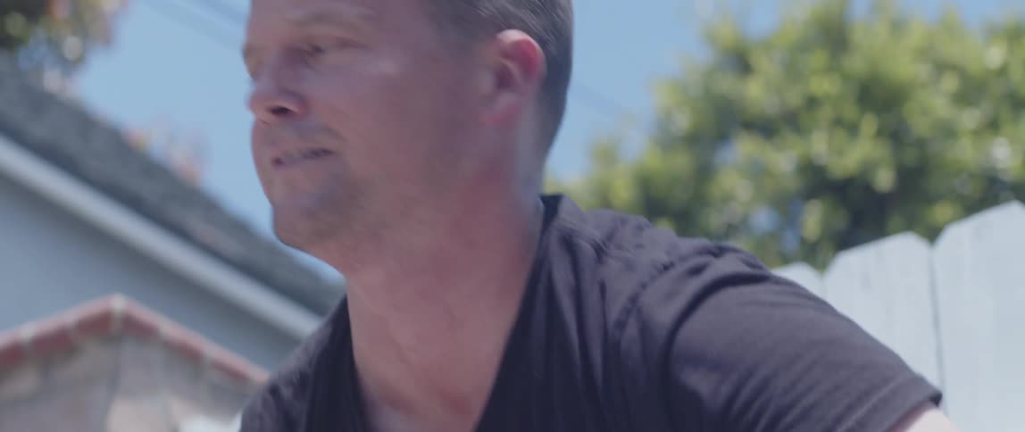 Close up of a man stacking broken bricks on his backyard on a sunny day
