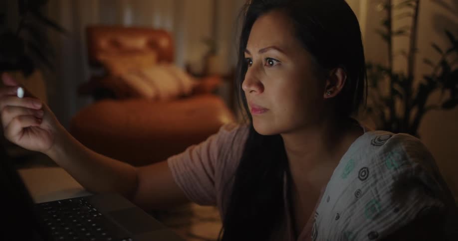 Woman sitting concentrated working on a tablet