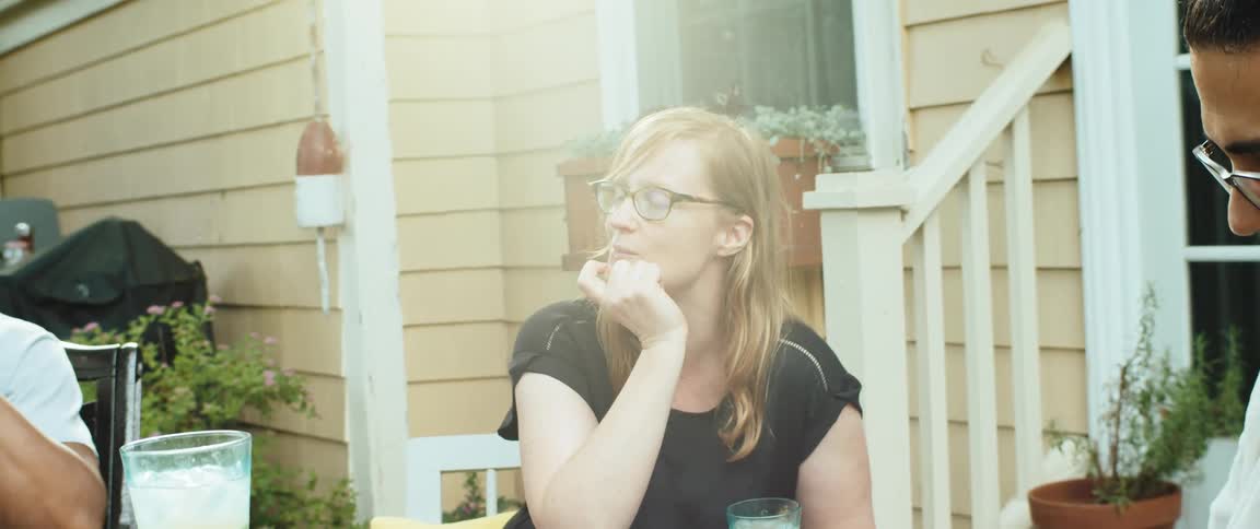 Friends are talking and having drinks in the yard