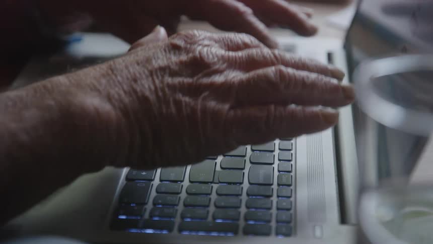 Hands of a person typing on a laptop